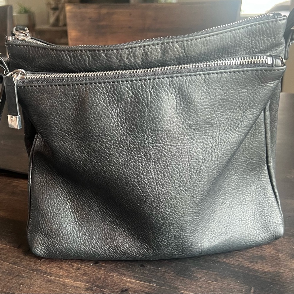 Black genuine leather Margot cross body bag. Double zip compartments.